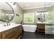 Ensuite bathroom featuring modern fixtures, large soaking tub, and and sinks at 415 Morgan Falls Chase, Canton, GA 30114