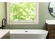 Bright bathroom with window view and a standalone white soaking tub at 415 Morgan Falls Chase, Canton, GA 30114