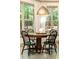 Charming breakfast nook features a round wooden table with black chairs and natural light from large windows at 415 Morgan Falls Chase, Canton, GA 30114