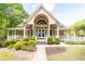 Community clubhouse with welcoming porch, stone landscaping and manicured lawn at 415 Morgan Falls Chase, Canton, GA 30114