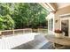 Inviting outdoor deck with a table and chairs, surrounded by trees, perfect for relaxing and entertaining at 415 Morgan Falls Chase, Canton, GA 30114