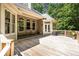 Wooden deck featuring a seating area with a table and chairs, perfect for outdoor relaxation and entertaining at 415 Morgan Falls Chase, Canton, GA 30114