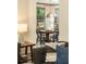 Dining room features a round table, black chairs, a unique hanging lamp, and large windows with sheer curtains at 415 Morgan Falls Chase, Canton, GA 30114