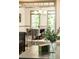 Bright dining room features hardwood floors, gray trim, modern chandelier and table with six comfortable gray chairs at 415 Morgan Falls Chase, Canton, GA 30114