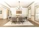 Formal dining room with dark wood table, six upholstered chairs, and modern chandelier at 415 Morgan Falls Chase, Canton, GA 30114