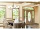 Dining room with table, six chairs, natural light, and an open view to the front door at 415 Morgan Falls Chase, Canton, GA 30114