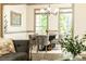 Elegant dining room with hardwood floors, gray trim, a modern chandelier, and large windows overlooking a green yard at 415 Morgan Falls Chase, Canton, GA 30114