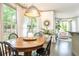 Bright dining room featuring hardwood floors, modern lighting, and large windows at 415 Morgan Falls Chase, Canton, GA 30114