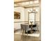 A dining room featuring a round table, six gray chairs, a modern chandelier, and a large picture window at 415 Morgan Falls Chase, Canton, GA 30114