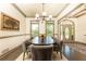 Dining room showcases a dark wood table, six chairs, and ample natural light with entrance view at 415 Morgan Falls Chase, Canton, GA 30114