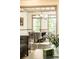 Bright dining room features hardwood floors, gray trim, modern chandelier and table with six comfortable gray chairs at 415 Morgan Falls Chase, Canton, GA 30114