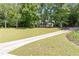 Charming home with a well-manicured lawn and mature trees, creating a peaceful and inviting setting at 415 Morgan Falls Chase, Canton, GA 30114