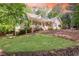 Charming home with a welcoming front porch and beautifully landscaped front yard at 415 Morgan Falls Chase, Canton, GA 30114