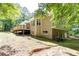 Exterior view of the home featuring a wooden deck with stairs and well-maintained lawn at 415 Morgan Falls Chase, Canton, GA 30114