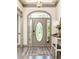Stylish foyer featuring a decorative front door, console table, and hardwood floors at 415 Morgan Falls Chase, Canton, GA 30114