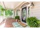 Welcoming front porch featuring a swing, plants, and an elegant front door with sidelights at 415 Morgan Falls Chase, Canton, GA 30114