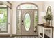 Elegant front door with decorative glass, sidelights, and a transom window creates a welcoming entrance at 415 Morgan Falls Chase, Canton, GA 30114