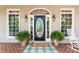 Inviting front porch with brick flooring, decorative plants, and a stylish front door at 415 Morgan Falls Chase, Canton, GA 30114
