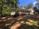 Charming front exterior with a covered porch, brick accents, a well-manicured lawn, and stone walkway at 415 Morgan Falls Chase, Canton, GA 30114