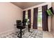 Home office with sleek desk, comfortable chair, and natural light from windows at 415 Morgan Falls Chase, Canton, GA 30114