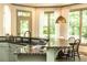 Eat-in kitchen featuring granite countertops, light green cabinets, stainless steel appliances, and breakfast nook at 415 Morgan Falls Chase, Canton, GA 30114