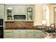 The kitchen features light green cabinets, modern appliances, and granite countertops with an opening to the dining room at 415 Morgan Falls Chase, Canton, GA 30114