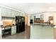 The kitchen features light green cabinets, stainless appliances, granite countertops, and a built-in desk at 415 Morgan Falls Chase, Canton, GA 30114