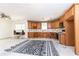 A kitchen with oak cabinets, countertops, and appliances awaits renovation to become the heart of the home at 415 Morgan Falls Chase, Canton, GA 30114