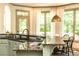Eat-in kitchen featuring granite countertops, light green cabinets, stainless steel appliances, and breakfast nook at 415 Morgan Falls Chase, Canton, GA 30114