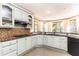 The kitchen features light green cabinets, modern appliances, granite countertops, hardwood floors, and a breakfast nook at 415 Morgan Falls Chase, Canton, GA 30114