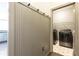 View of a laundry room with modern washer and dryer, decorative molding, and storage at 415 Morgan Falls Chase, Canton, GA 30114