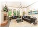 Comfortable living room features a brick fireplace, large windows, and two plush sofas at 415 Morgan Falls Chase, Canton, GA 30114