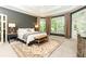 Spacious main bedroom with a tray ceiling, large windows, and neutral carpet at 415 Morgan Falls Chase, Canton, GA 30114