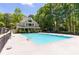 Community pool and building with a beautiful sun deck and shaded seating at 415 Morgan Falls Chase, Canton, GA 30114