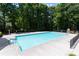 Community pool and sun deck surrounded by tall trees and privacy fencing at 415 Morgan Falls Chase, Canton, GA 30114