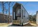 Striking modern home featuring clean lines, a balcony, and sleek design elements at 100 Dahlia Nw Ave, Atlanta, GA 30314