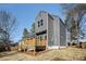 Charming two-story home with a modern gray exterior and wooden deck at 100 Dahlia Nw Ave, Atlanta, GA 30314