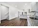 Open-concept kitchen boasts granite countertops and dark wood flooring at 100 Dahlia Nw Ave, Atlanta, GA 30314