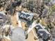 Aerial view of a luxury home with a circular driveway on a manicured cul-de-sac lot surrounded by mature trees at 1594 Stoddard Nw Ct, Kennesaw, GA 30152