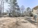 Wide shot of a property's backyard featuring mature trees and playhouse at 1594 Stoddard Nw Ct, Kennesaw, GA 30152