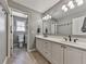 This neutral bathroom features double sinks with matte black fixtures and tiled floors at 1594 Stoddard Nw Ct, Kennesaw, GA 30152