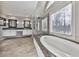 A spacious bathroom with dual vanities, a soaking tub, and a glass-enclosed shower at 1594 Stoddard Nw Ct, Kennesaw, GA 30152