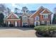 Charming brick home featuring a well-manicured lawn and traditional architectural details at 1594 Stoddard Nw Ct, Kennesaw, GA 30152