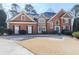 Stately brick home with a manicured lawn and a grand entrance offers timeless elegance and curb appeal at 1594 Stoddard Nw Ct, Kennesaw, GA 30152