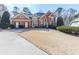 Attractive brick home with detailed window features and a landscaped lawn exudes classic charm and curb appeal at 1594 Stoddard Nw Ct, Kennesaw, GA 30152