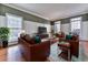 Comfortable living room showcases hardwood floors, modern furniture, and lots of natural light at 1594 Stoddard Nw Ct, Kennesaw, GA 30152