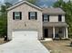 Charming two-story home with a brick facade, black shutters, covered porch and two car garage at 3604 Sw Wartrace Sw Dr, Atlanta, GA 30331