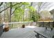 White wooden deck with gray flooring with trees and green grass in the background at 455 Cooper Woods Se Ct, Smyrna, GA 30082