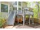 Exterior backyard view of house featuring a raised deck with stairs and small mulched area at 455 Cooper Woods Se Ct, Smyrna, GA 30082