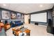 Basement media room with projector screen, blue sofa, movie posters, and speakers at 455 Cooper Woods Se Ct, Smyrna, GA 30082